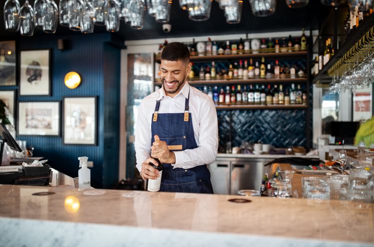 business proposal for bar and restaurant Bartender opening a bottle of wine