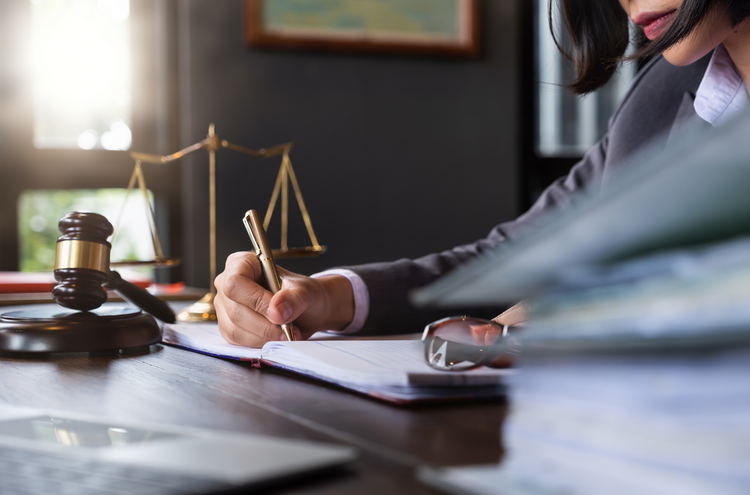 lawyer working on a documents with gavel on table
