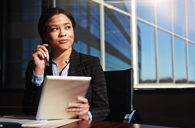 Shot of a young lawyer contemplating while using her digital tablet